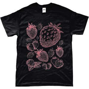 May include: Black t-shirt with a pink strawberry print. The strawberries are drawn in a vintage style and are scattered across the shirt.