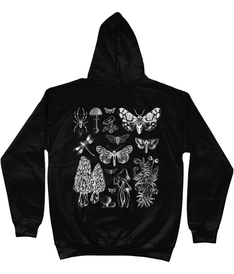 May include: Black hooded sweatshirt with a white print of various insects, mushrooms, and plants. The print includes a spider, dragonfly, moths, butterflies, and mushrooms.
