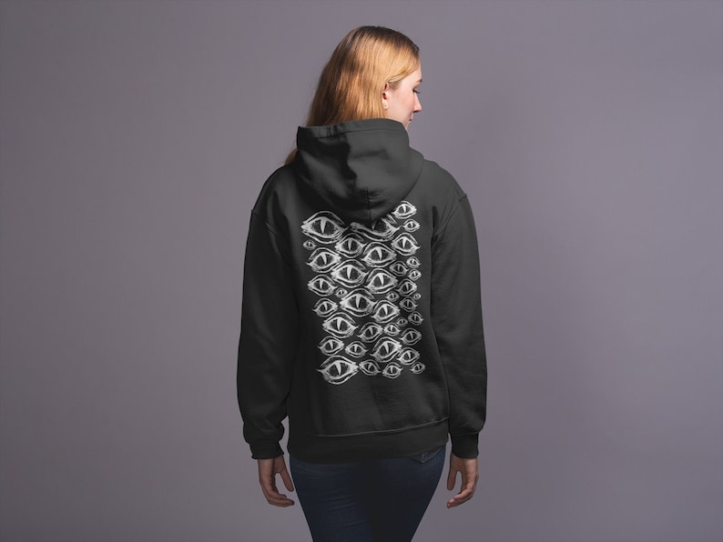 May include: Black hooded sweatshirt with a white graphic print of multiple eyes on the back.