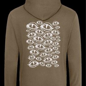 May include: A brown hooded sweatshirt with a white graphic print of multiple stylized eyes on the back.
