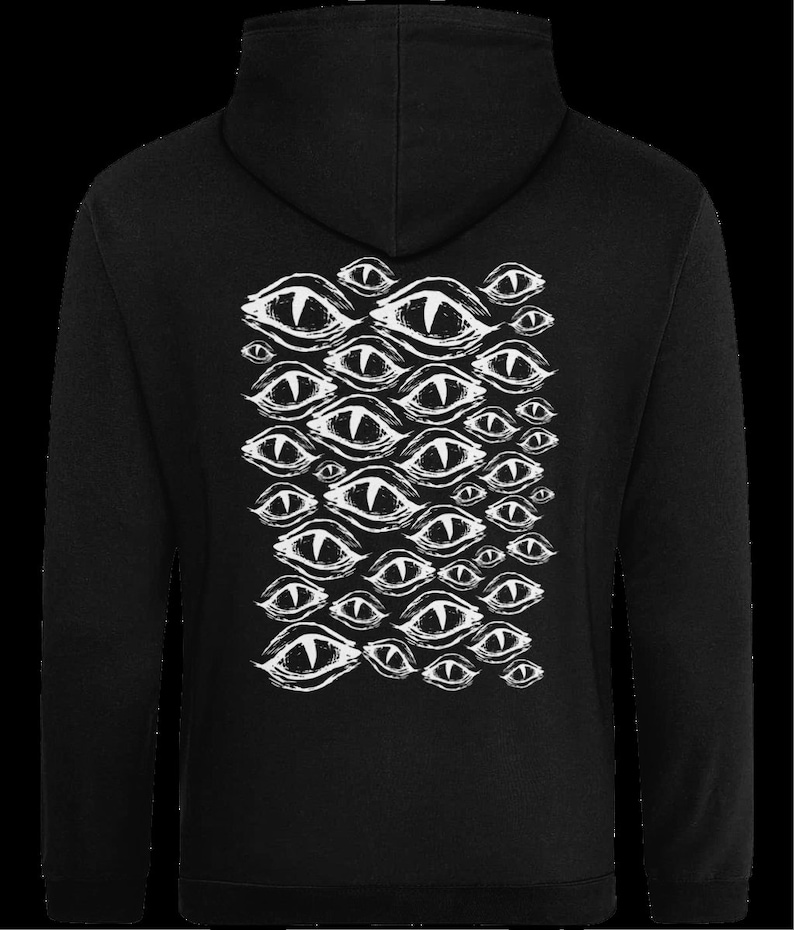 May include: Black hooded sweatshirt with a white graphic print of multiple stylized eyes.