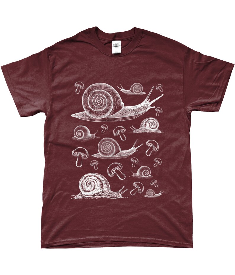 May include: A maroon t-shirt with a white graphic print of snails and mushrooms. The snails are of varying sizes and are depicted in a vintage style.