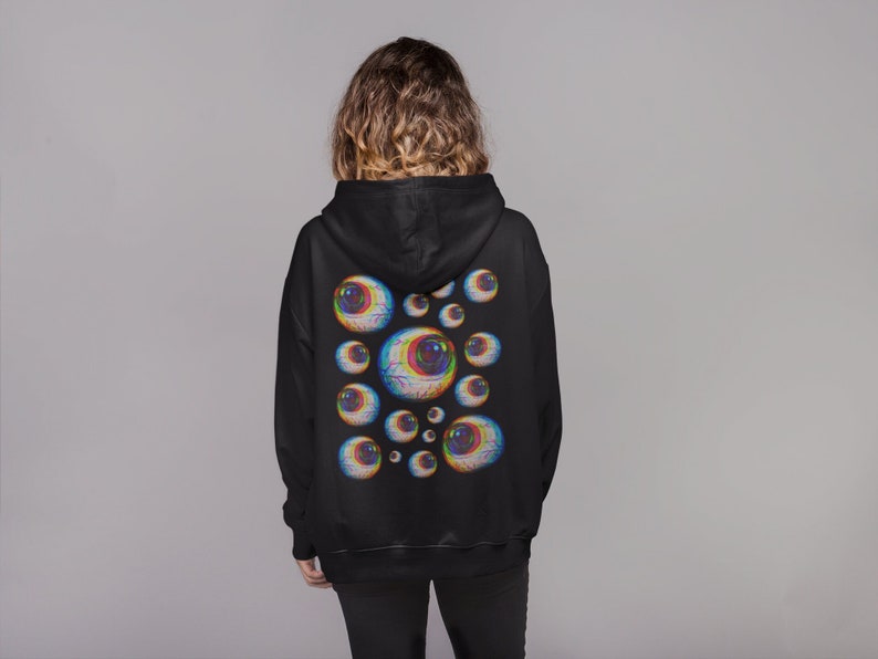 May include: Black hoodie with a graphic print of multiple colorful eyes on the back.