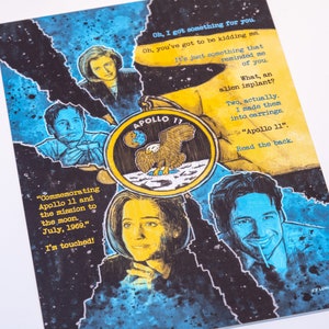 May include: A yellow and black illustration of the Apollo 11 mission patch with a bald eagle landing on the moon. The image is surrounded by four portraits of people, with text that reads "Commemorating Apollo 11 and the mission to the moon. July, 1969." and "Oh, I got something for you. Oh, you've got to be kidding me. It's just something that reminded me of you. What, an alien implant? Two, actually. I made them into earrings. "Apollo 11". Read the back."