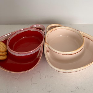 May include: A white ceramic mug with a black handle and the text "But First, Coffee" in a handwritten style. The mug is on a white surface. The mug is likely used for hot beverages.