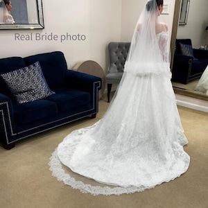 Real bride wearing chapel length wedding veil with blusher in light ivory, Chantilly lace trim