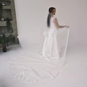 Two-tier wedding veil showing 80 cm blusher and long cathedral layer in light ivory tulle