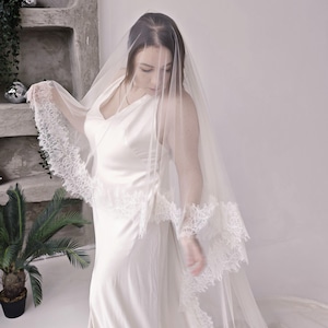 Cathedral veil with blusher Chantilly lace trim edge on model