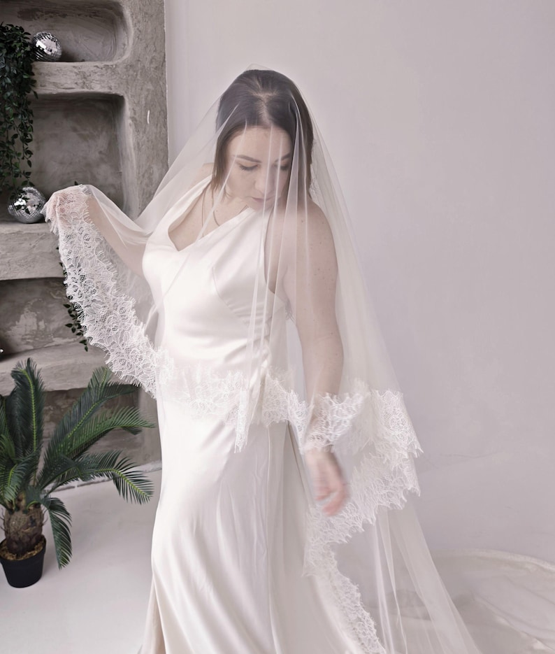 Cathedral veil with blusher Chantilly lace trim edge on model
