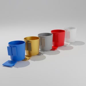 May include: A set of three ceramic mugs with a speckled, matte finish. The mugs are in shades of cream, light gray, and dark gray. Each mug has a simple, minimalist design, perfect for coffee or tea.