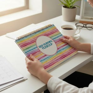 May include: A spiral-bound notebook featuring a colorful horizontal striped pattern in shades of pink, blue, yellow, and green. A central white oval contains the text "Raid Planning Notebook" in a dark blue, rounded, sans-serif font.