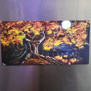 May include: A painting of a large tree with autumn leaves in shades of orange, yellow, and red. The tree is in a dark forest with a full moon in the background. There are pumpkins in the foreground.