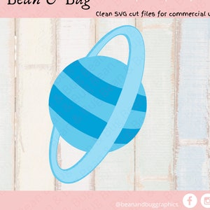 May include: A blue and white planet with a ring around it. The planet has a striped pattern and the ring is a single, thick band. The image is on a white wood background.