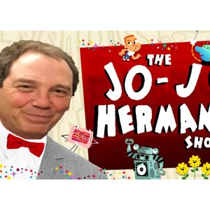 May include: A man wearing a gray suit and a red bow tie smiles at the camera. The background is a red and white illustration with the text "The Jo-Jo Hermann Show" and colorful cartoon characters.