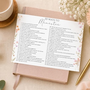 May include: A notebook with a list titled "50 Ways to Minister" is displayed on a light brown book. A gold pen and a cup of coffee are next to the book. Floral accents and text are visible.