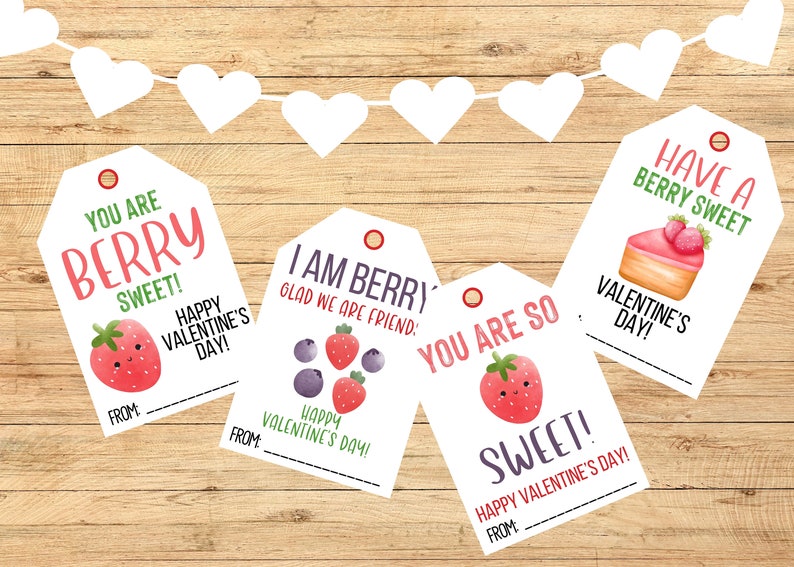 May include: Four white gift tags with red and green berry designs and Valentine's Day messages. The tags have a hole punched in the top and are decorated with a red circle. The text on the tags reads: "You are berry sweet! Happy Valentine's Day!", "I am berry glad we are friends! Happy Valentine's Day!", "You are so sweet! Happy Valentine's Day!" and "Have a berry sweet Valentine's Day!"