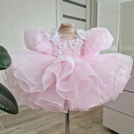 Incredibly Fluffy Light Pink, Glitter Baby Dress with Big Puffy Sleeves, Embellished with White Flowers and Petals.