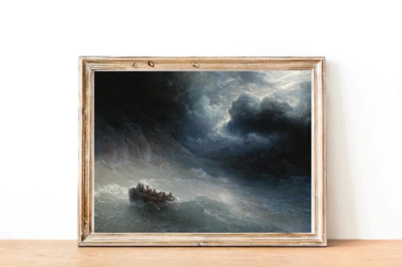 May include: A framed painting depicting a stormy seascape with a small boat carrying people through rough waves. The sky is dark and dramatic with large, ominous clouds. The painting is framed in a light wood frame.