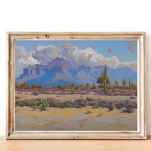 Puede incluir: Una pintura enmarcada que representa un paisaje des&eacute;rtico con una cordillera en el fondo. El cielo es azul con nubes blancas y el primer plano es un desierto arenoso con cactus y otras plantas del desierto.