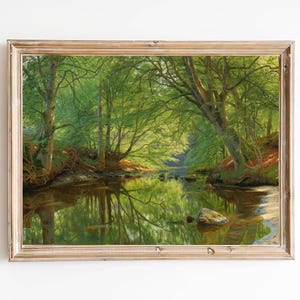 May include: A framed oil painting depicting a lush green forest with a winding river flowing through it. The trees are tall and thick, and the river is calm and reflective. The sunlight is dappled through the leaves, creating a sense of peace and tranquility.