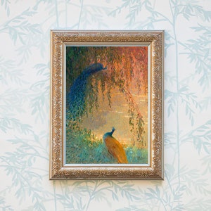 Op de afbeelding: Een ingelijst schilderij van twee pauwen in een bosrijke omgeving. De pauwen staan onder een treurwilg met hun staarten gespreid. Het schilderij is gemaakt in pointillistische stijl en heeft een zachte, dromerige uitstraling.