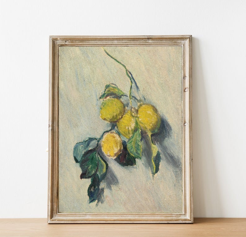 May include: A framed painting of a still life featuring a branch of lemons with green leaves against a light blue background.