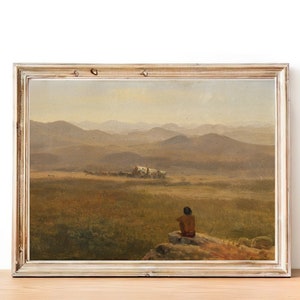 Op de afbeelding: Een ingelijst olieverfschilderij dat een landschapsscene toont met een eenzame figuur die op een rots in de voorgrond zit. De figuur kijkt uit naar een ver weg gelegen karavaan die door een vallei trekt. Het schilderij is geschilderd tegen een achtergrond van glooiende heuvels en een wazige lucht.