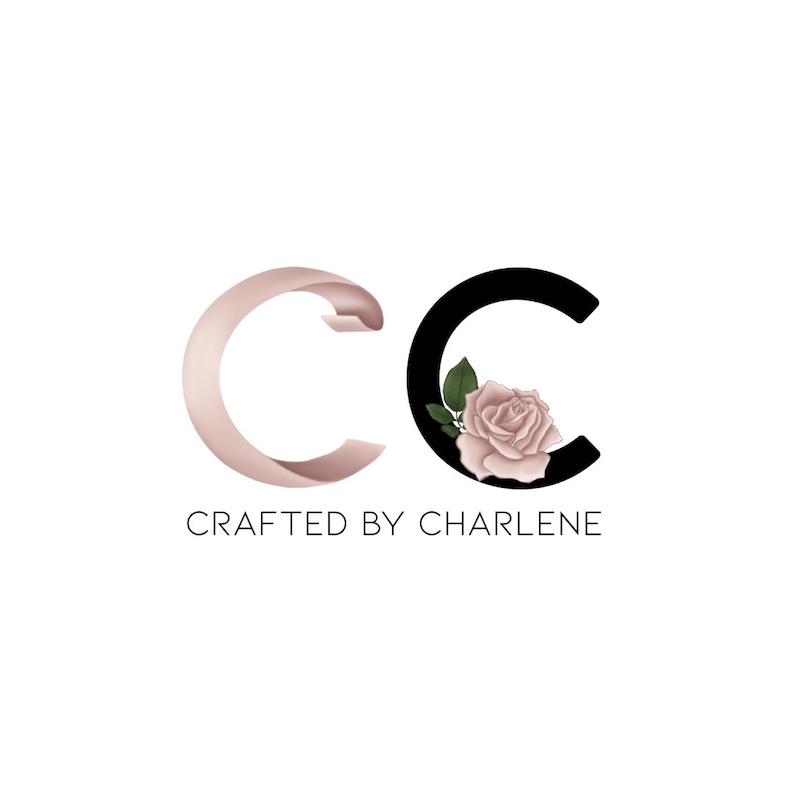 May include: A logo with the letters "CC" in black and pink. The "C" on the right has a pink rose with green leaves inside. The text "CRAFTED BY CHARLENE" is below the letters.
