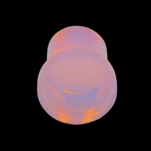 May include: A pearlescent, teardrop-shaped object with a smooth, reflective surface. The color transitions from a soft pink to a lavender hue, with hints of orange. The object is set against a stark black background.