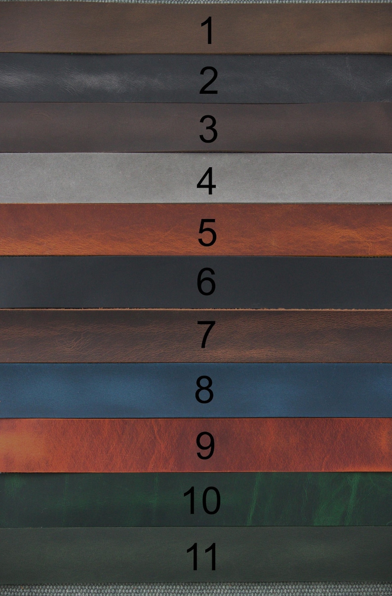 May include: A collection of eleven horizontal leather strips arranged in a stack, each labelled with a black number from 1 to 11. The strips display a variety of colours including shades of brown, grey, black, blue, red-brown, and dark green.
