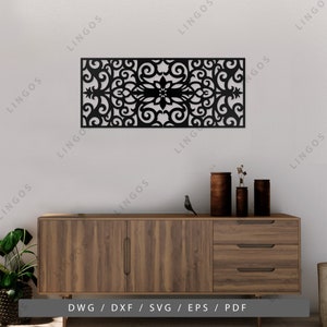 May include: Black metal wall decor featuring a decorative floral design. The decor is mounted on a white wall above a wooden dresser with three drawers.