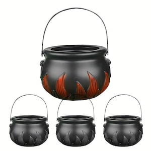 May include: A set of four black plastic cauldrons, each featuring a rounded body with molded flame-like details around the base and a thin metal wire handle. The largest cauldron is positioned at the top, while three smaller ones are below it.
