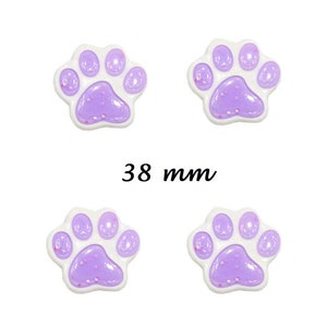 May include: Four purple and white paw print shaped buttons with glitter. The buttons are 38 mm in diameter.