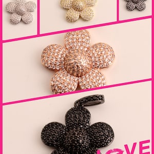 May include: Four flower-shaped pendants with a pave setting of clear stones. The pendants are in silver, gold, rose gold, and black.