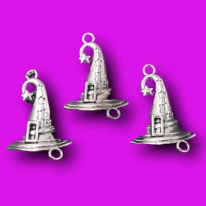 May include: Three silver witch hat charms with a star on the top of each hat. The hats have a silver buckle and a loop for hanging.