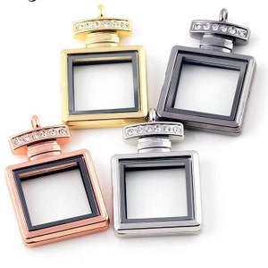 May include: Four perfume bottle charms with clear glass inserts and rhinestone accents. The charms are in gold, silver, black, and rose gold.