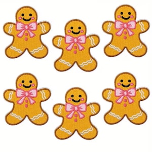 May include: Six embroidered gingerbread man patches. Each patch is yellow with a pink bow tie and a smiling face. The patches have a white border and are arranged on a white background.