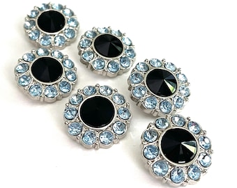 May include: Six silver-toned buttons with a floral design. Each button features a large, black center stone surrounded by a ring of light blue rhinestones. The buttons are arranged on a white background.