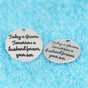 May include: Two silver round charms with the text "Today a Groom Tomorrow a husband forever your son" on each charm.