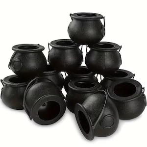 May include: A collection of twelve small black plastic cauldrons arranged in a pyramid stack. Each cauldron features a rounded body, a wide circular opening at the top, and a thin, movable handle attached to the sides with circular mounts.