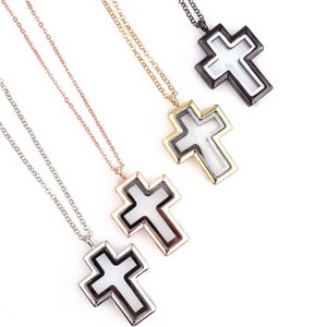 May include: Four silver, gold, rose gold, and black cross necklaces with a clear glass insert. The cross pendants are all the same size and shape.
