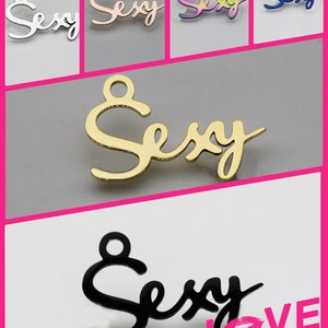 May include: Five different colored metal charms with the word "Sexy" written in a cursive font. The charms are silver, rose gold, rainbow, blue, and gold.
