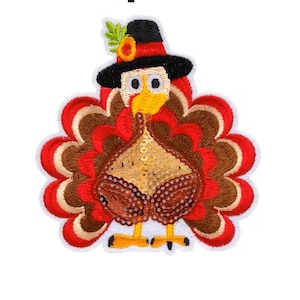 May include: An embroidered iron-on patch featuring a turkey wearing a black hat with a red band and a small yellow flower. The turkey has a brown and red fanned tail, a gold-toned body, and orange feet, all outlined in white thread.