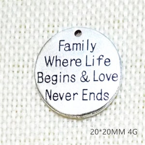 May include: Silver charm with the text "Family Where Life Begins & Love Never Ends" on a white background. The charm is 20mm in diameter.