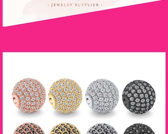 May include: Six round beads with a pave setting of small clear stones. The beads are in three different metal finishes: rose gold, gold, silver, and black. The beads are arranged in two rows of three.