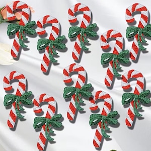 May include: Embroidered candy cane patches with red and white stripes and a green bow. These festive patches are perfect for holiday-themed crafts and decorations. Each patch is approximately 3 inches in length.
