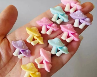 May include: A collection of pastel-colored mushroom-shaped charms with white polka dots. The charms are made of polymer clay and are perfect for adding a whimsical touch to crafts and jewelry.