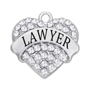 May include: Silver heart-shaped charm with clear rhinestones and a black banner that reads "LAWYER".
