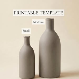 May include: Two matte gray vases of different heights, labeled Small and Medium, presented as a printable template. The vases feature a narrow neck and a rounded body, standing upright against a plain, light-colored background.
