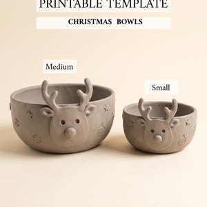 May include: Two gray ceramic bowls labeled Medium and Small, featuring a raised reindeer face on the front and embossed star and ornament patterns. The text PRINTABLE TEMPLATE CHRISTMAS BOWLS appears at the top of the image.